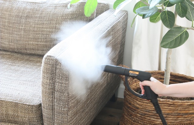 Steam cleaning a sofa