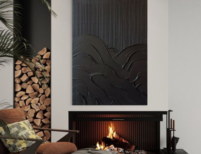 3D plaster wall art installed over a fireplace